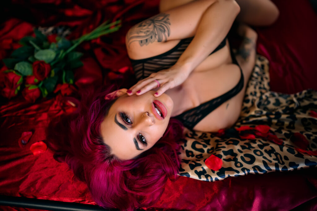 Woman laying on bed in lingerie, Lanora Ronee Photography's empowering and body-positive boudoir photoshoot in Colleyville, Texas, showcasing women of all ages and sizes