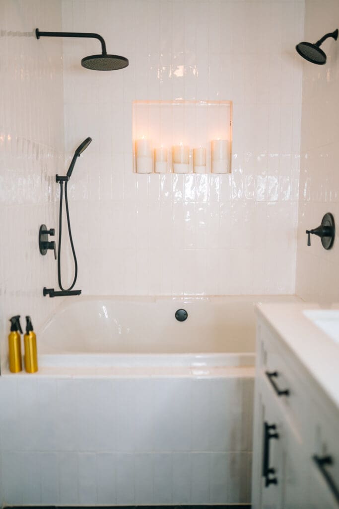 Bright white tub and shower boudoir set with black fixtures inside Lanora Ronée Photography in Fort Worth.
