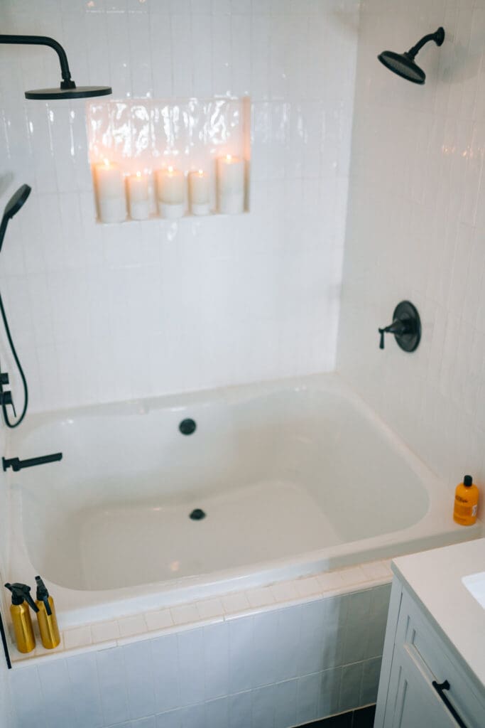 Bright white tub and shower boudoir set with black fixtures inside Lanora Ronée Photography in Fort Worth.