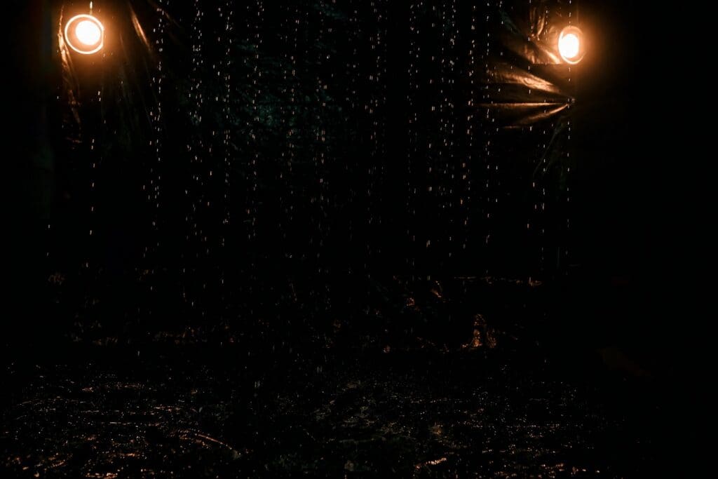 Dark Rain Room boudoir photography set with falling water at Lanora Ronée Photography in Fort Worth Texas.